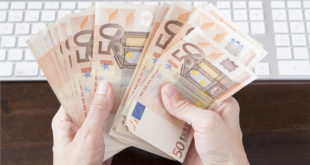 holding money desk keyboard mainjpg A third of employees would sell your company data