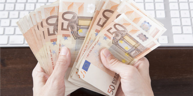 holding money desk keyboard mainjpg A third of employees would sell your company data